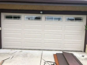 Beige garage door with decorative windows - Garage Door installation San Antonio TX